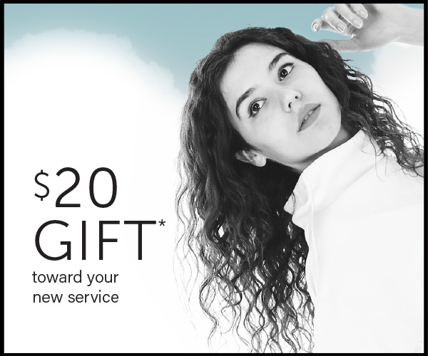 Woman with curly hair looking upwards, a "$20 gift towards your new service" text overlay on the left side. - K. Charles & Co. in Schertz, TX