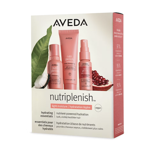 A product box of aveda nutriplenish featuring shampoo, conditioner, and leave-in conditioner with pomegranate and cotton plant decorations. - K. Charles & Co. in Schertz, TX
